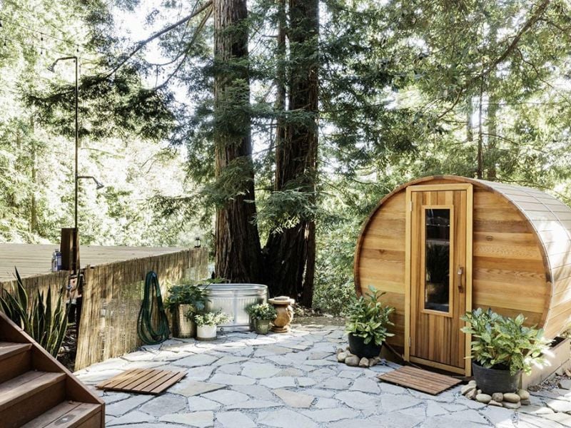 Cedar barrel sauna in a backyard, ready to relocate