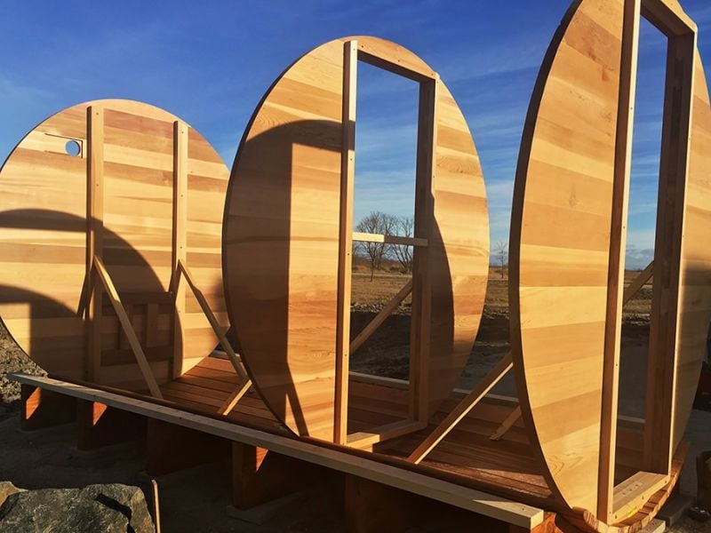Cedar barrel sauna with a large tempered glass door